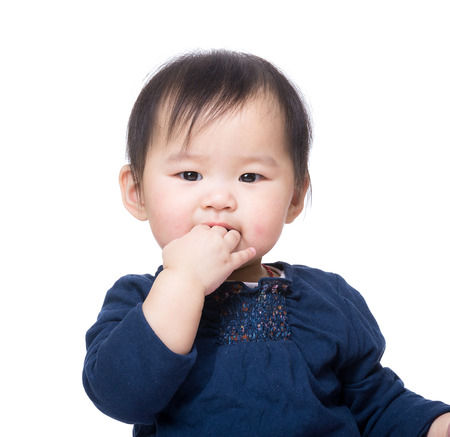 Asia baby girl suck finger into mouthの写真素材