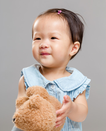 Little girl with doll bearの写真素材