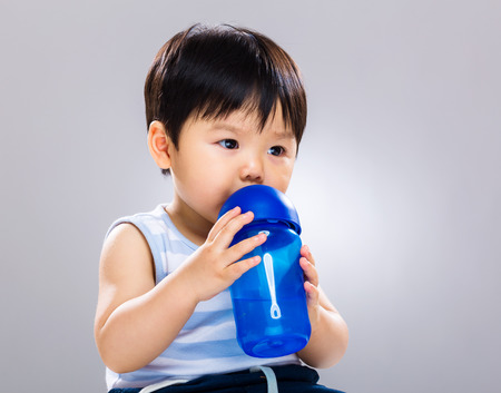 Little boy drinking waterの写真素材