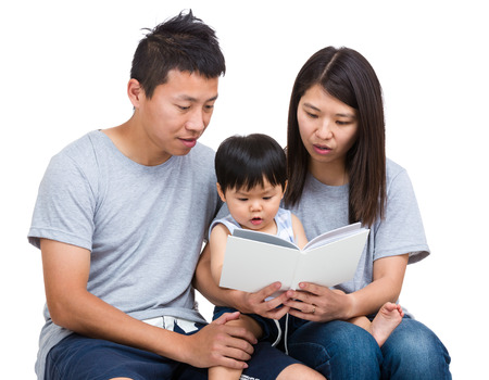 Asian parent reading booking with baby sonの写真素材