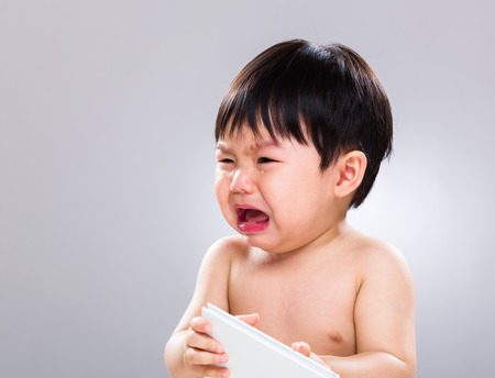 Baby cry with bookの写真素材