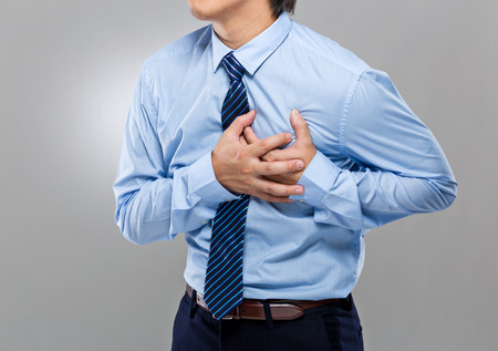 Businessman with heart attackの写真素材