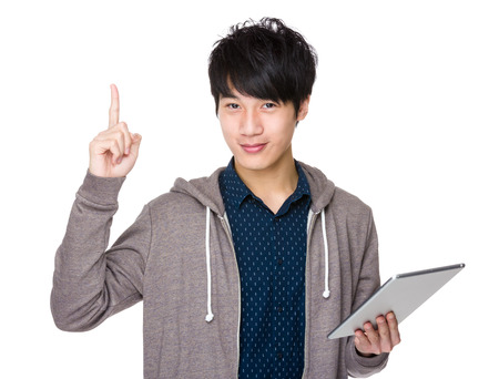 Man use of tablet and finger show upの写真素材