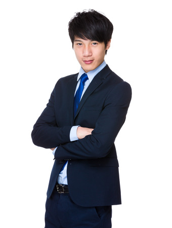 Handsome young asian man standing wearing a suitの写真素材