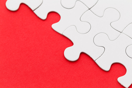 Jigsaw puzzle on red paperの写真素材