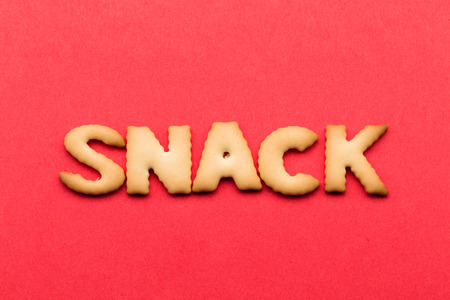 Word snack cookie over the red backgroundの写真素材