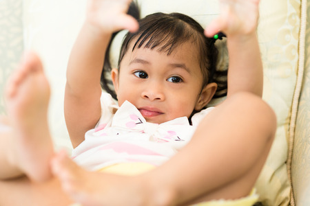 Little girl lay down on the sofaの写真素材