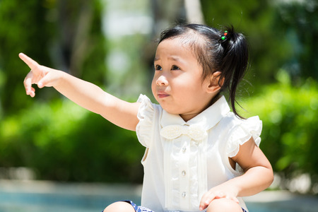 Little girl finger point to the other sideの写真素材