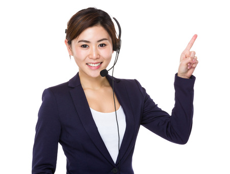 Call centre agent with finger point upwardsの写真素材