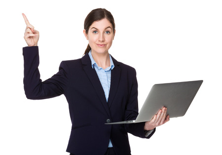 Brunette businesswoman use of the notebook computer and finger point upの写真素材
