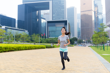 Woman running fast at Hong Kongの写真素材