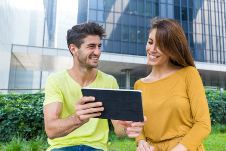 Caucasian discuss something show on tablet pc