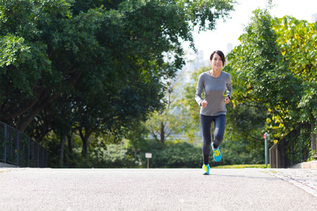 Young woman running at parkの写真素材