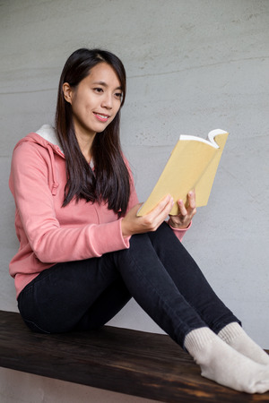 Woman reading book at homeの写真素材