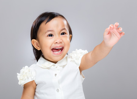 Baby girl excite with hand upの写真素材