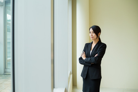 Asian Businesswoman standing at officeの写真素材