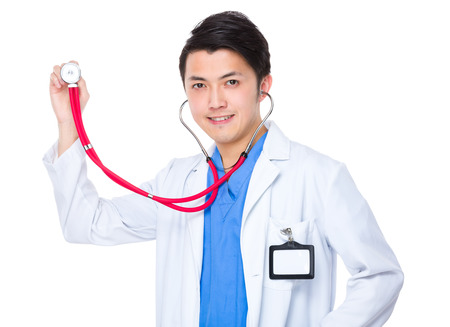 Asian young doctor holding up with stethoscopeの写真素材