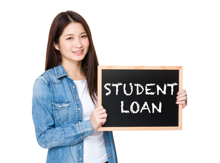 Woman with chalkboard showing phrase of student loanの写真素材