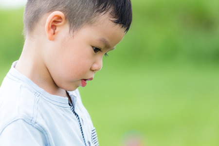 Little boy looking downの写真素材