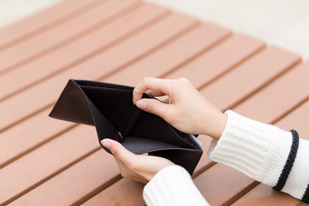 Woman holding an empty walletの写真素材