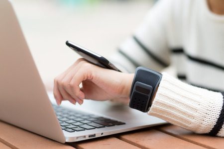 Woman connect with smart watch and cellphone