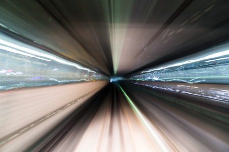 Light trail accelerating through a tunnelの写真素材