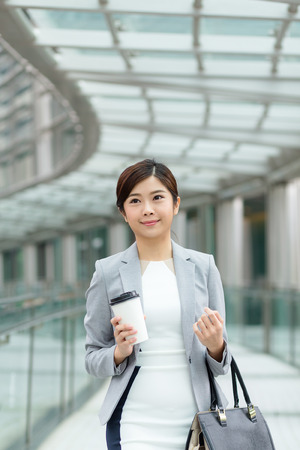 Businesswoman walking at pedestrian bridge in Hong Kongの写真素材