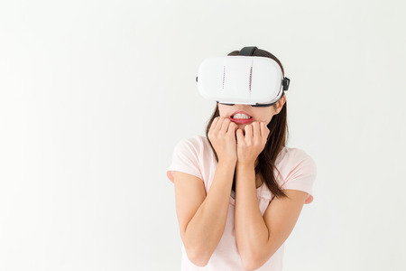 Woman watch scary movie via VR deviceの写真素材