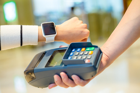 Woman paying with smartwatch by NFCの写真素材