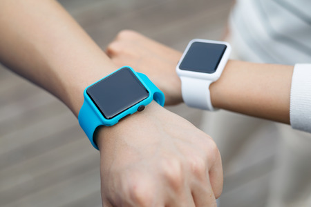 Couple using smart watch togetherの写真素材