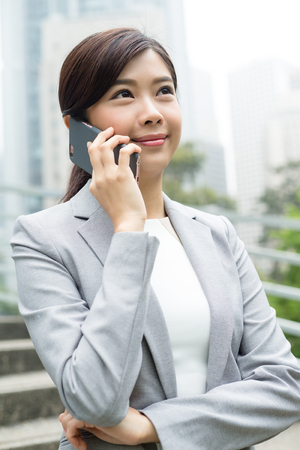 Businesswoman chat on cellphoneの写真素材