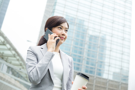 Businesswoman chat on mobile phoneの写真素材