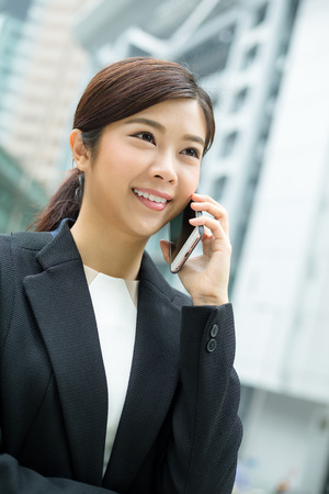 Businesswoman chat on cellphoneの写真素材