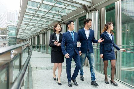Group of business people walking at bridgeの写真素材