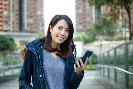 Woman use of cellphone at outdoorの写真素材