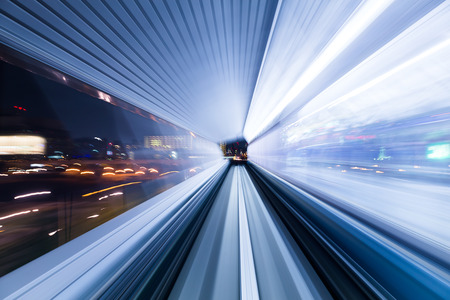 Light trail accelerating through a tunnelの写真素材