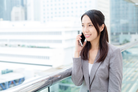 Business woman talk to mobile phoneの写真素材