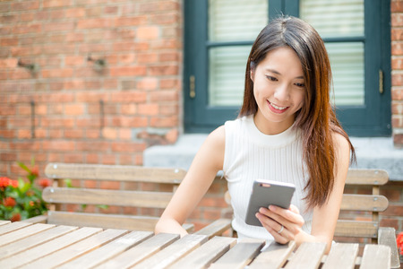 Young Woman sending message on cellphoneの写真素材