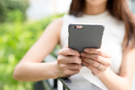 Woman holding a phoneの写真素材