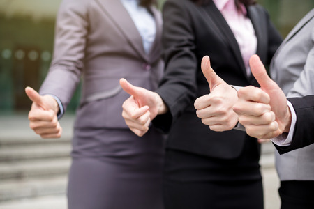 Business group giving thumbs up