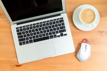 Laptop with fresh cup of coffeeの写真素材