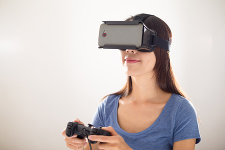 Young Woman play game with virtual reality deviceの写真素材