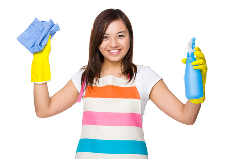 Asian housewife using the rag and bottle sprayの写真素材
