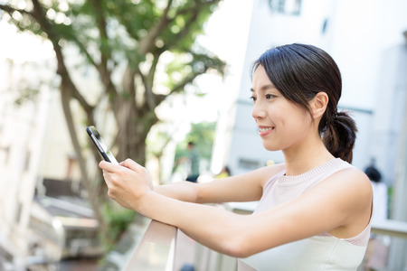 Woman sending sms on phoneの写真素材