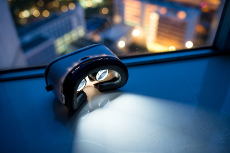 Virtual reality headset with cityscape backgroundの写真素材