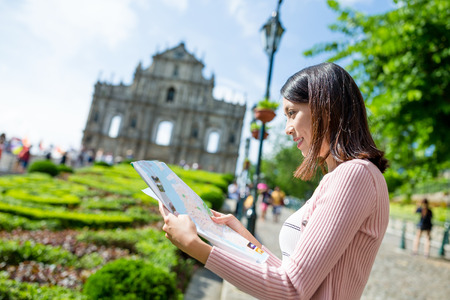Woman checking on city map