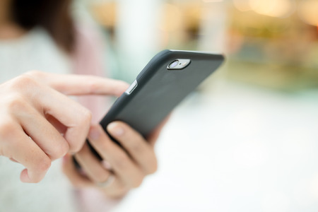 Woman hold with mobile phoneの写真素材