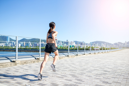 Woman running in city of Hong Kongの写真素材