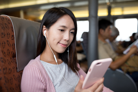 Woman listen to msuic on cellphoneの写真素材