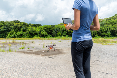 Woman control flying droneの写真素材